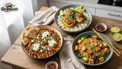 Three healthy and quick recipe jalbiteworldfood meals on a wooden table, including turmeric chicken, lamb skillet, and sesame noodles by RecipeGrids.
