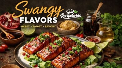 Three glossy pomegranate-glazed salmon fillets topped with sesame seeds, spring onions, and pomegranate arils, resting on creamy yogurt and cucumber ribbons. Surrounded by recipe ingredients like hot honey, fresh limes, and dark molasses.